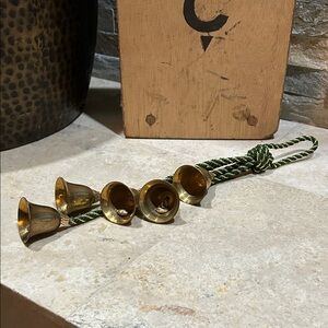 Vintage brass bells on a hanging rope